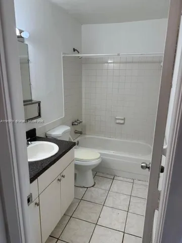 a bathroom with a sink toilet and mirror