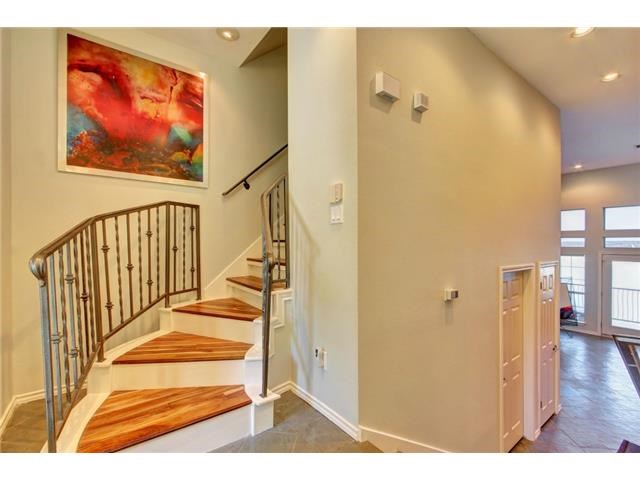 2918 Ranch Road 620, Unit K170 Austin, TX 78734 - Photo 4 of 22 Crafted wooden stairs ascend gracefully, framed by elegant wrought iron railings.