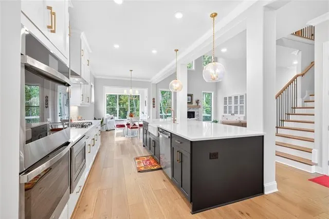 a bathroom with a sink a toilet and a large mirror