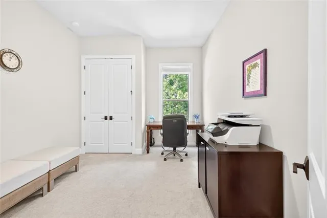 a kitchen with stainless steel appliances granite countertop a sink a stove a refrigerator and white cabinets with wooden floor