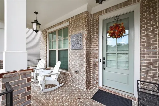 a large white kitchen with stainless steel appliances