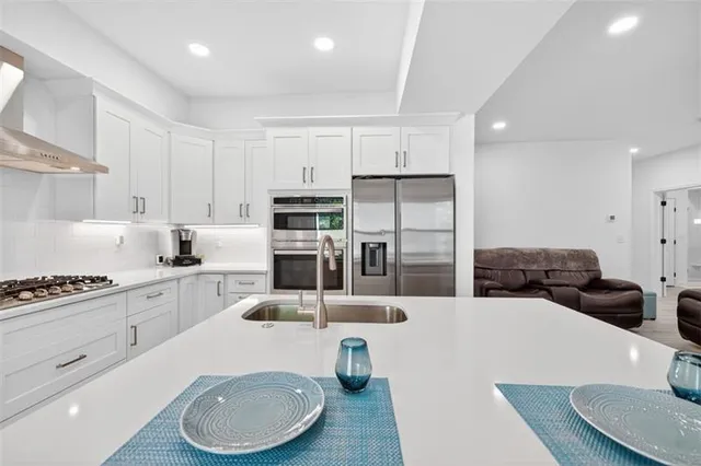 an aerial view of a house a yard and lake