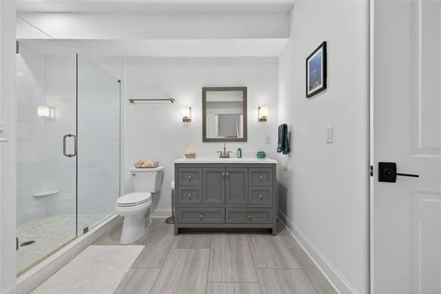 an aerial view of residential houses with outdoor space and trees