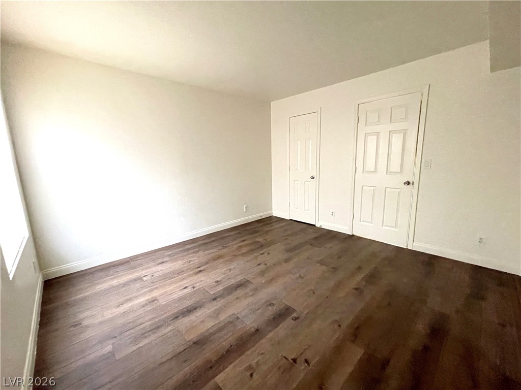 3135 South Mojave Road, Unit 221 Las Vegas, NV 89121 - Photo 14 of 19 Rich hardwood floors complement this ample bedroom space.