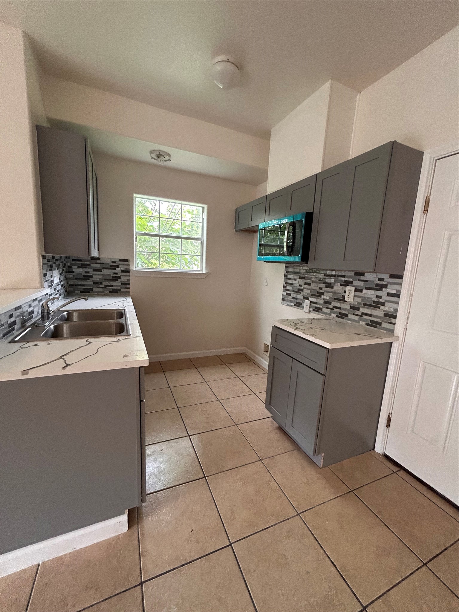 6841 Larkstone Street, Unit B Houston, TX 77028 - Photo 1 of 11 a kitchen with a stove a sink and a refrigerator