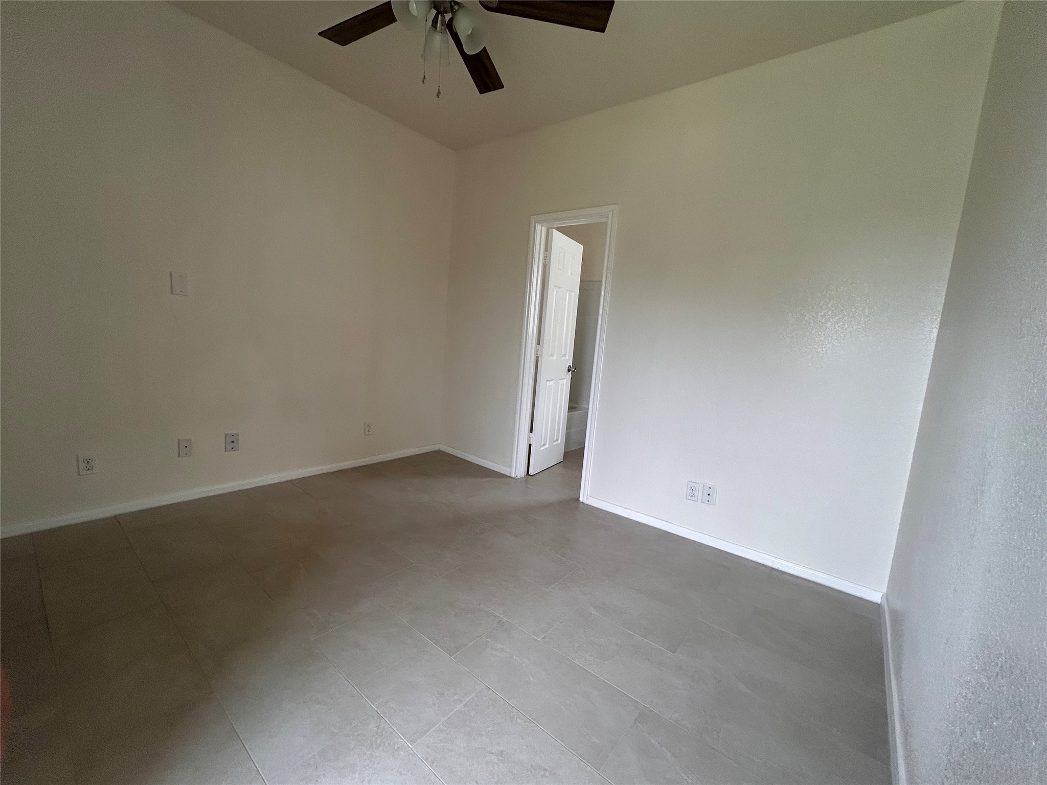 6841 Larkstone Street, Unit B Houston, TX 77028 - Photo 2 of 11 an empty room with a empty space and a ceiling fan