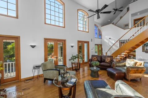 a living room with furniture and floor to ceiling windows