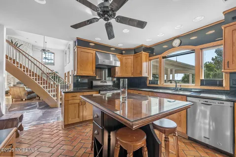 a kitchen with granite countertop lots of counter top space and wooden floor