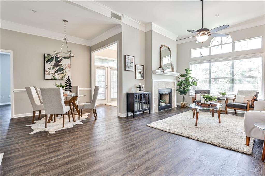 2700 Pine Tree Road Northeast, Unit 2301 Atlanta, GA 30324 - Photo 1 of 1 a living room with fireplace furniture and a wooden floor