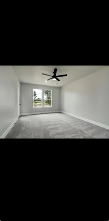 a view of kitchen island a sink wooden floor and a living room view