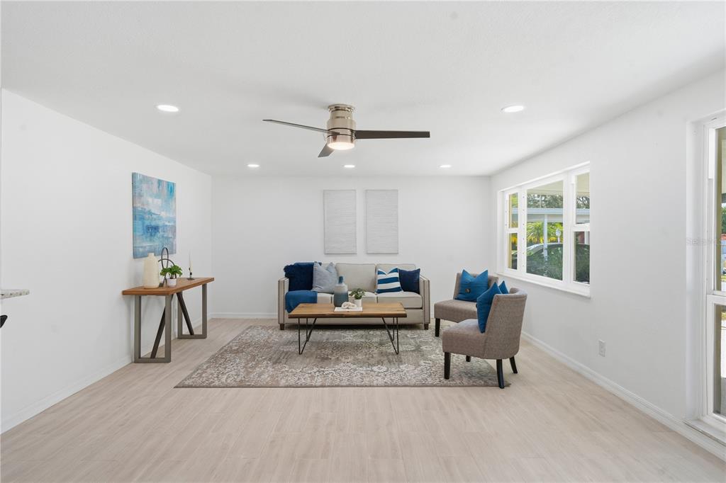 613 Highview Circle North Brandon, FL 33510 - Photo 13 of 37 a living room with furniture a window and a chandelier