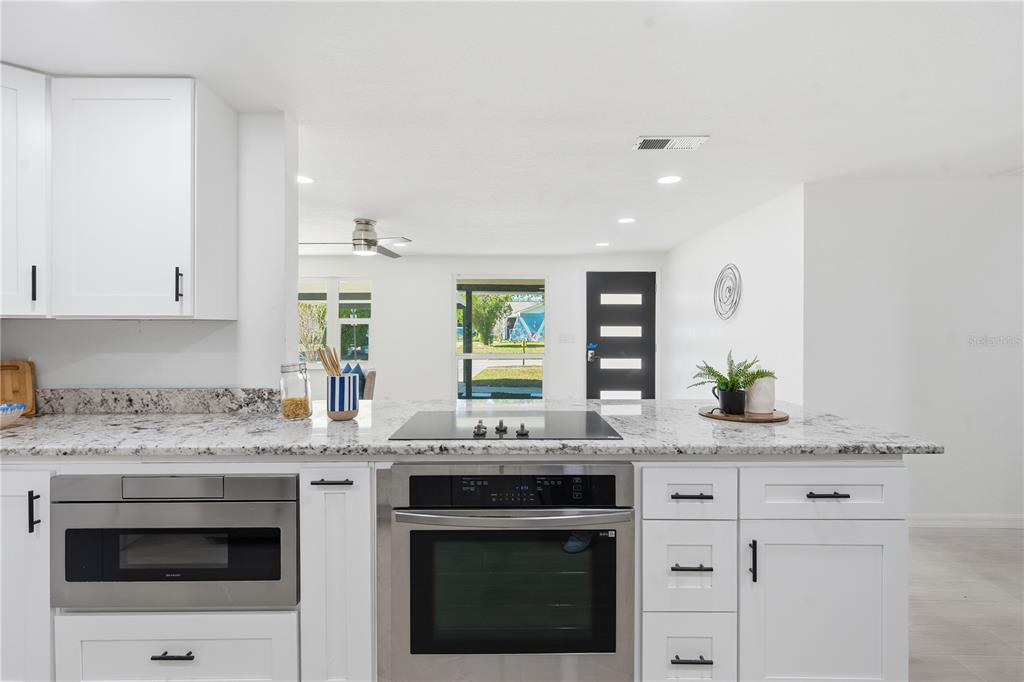 613 Highview Circle North Brandon, FL 33510 - Photo 18 of 37 a kitchen with stainless steel appliances granite countertop a sink stove and cabinets