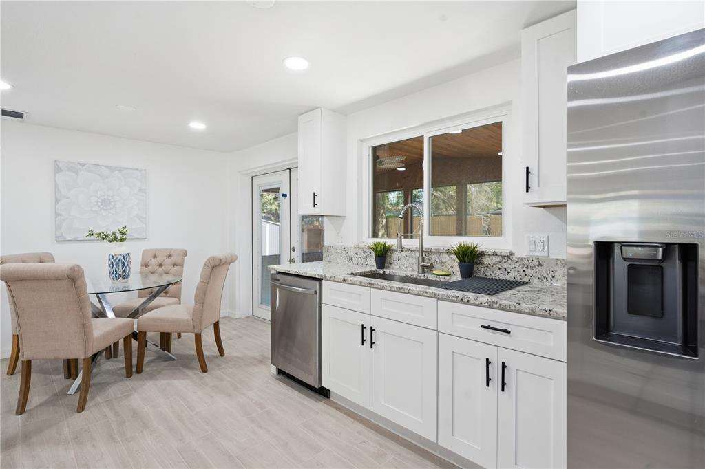 613 Highview Circle North Brandon, FL 33510 - Photo 20 of 37 a kitchen with granite countertop white cabinets and white appliances