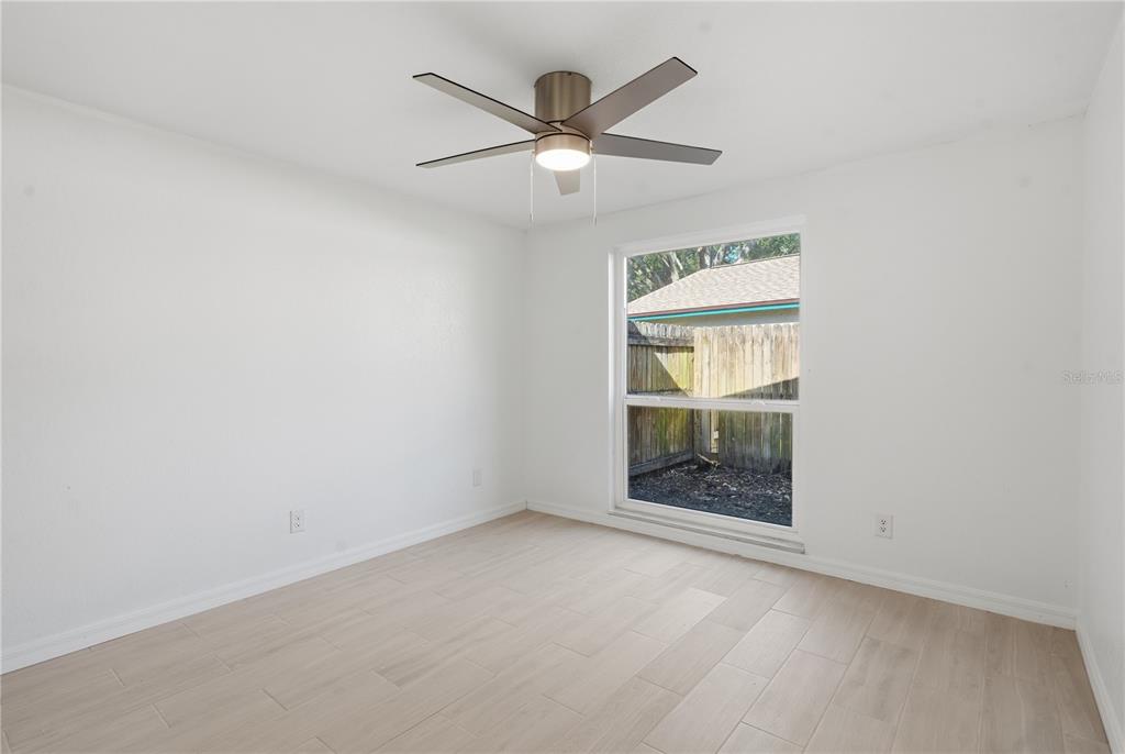 613 Highview Circle North Brandon, FL 33510 - Photo 24 of 37 an empty room with windows and fan
