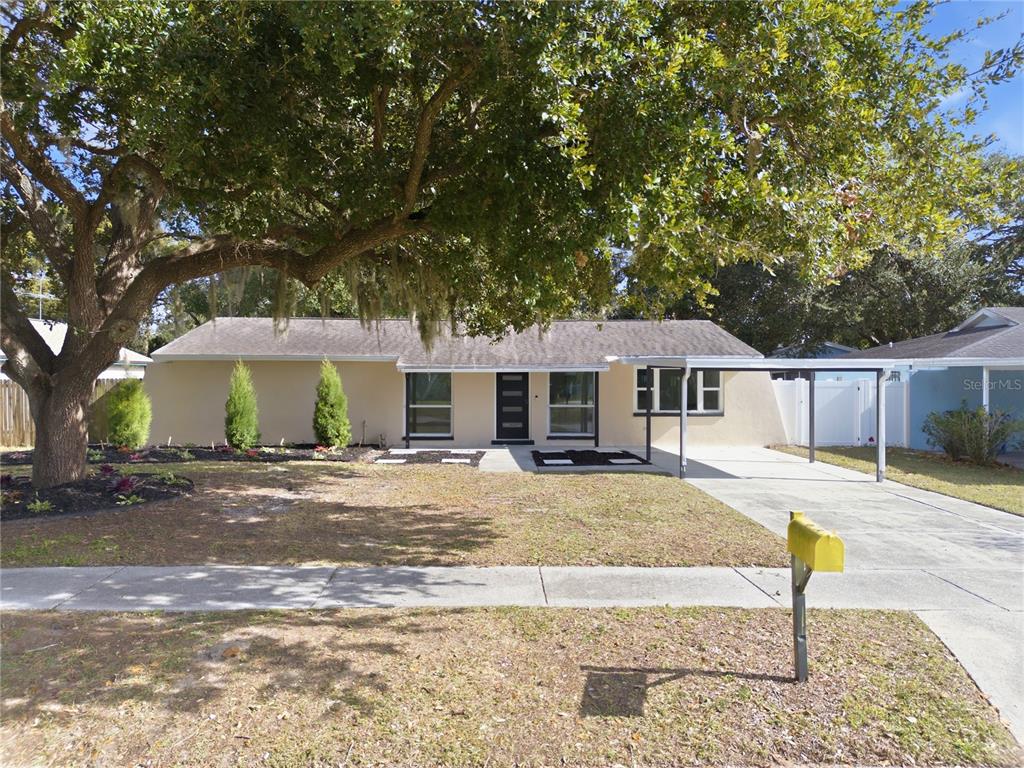 613 Highview Circle North Brandon, FL 33510 - Photo 3 of 37 a front view of a house with a yard and large tree