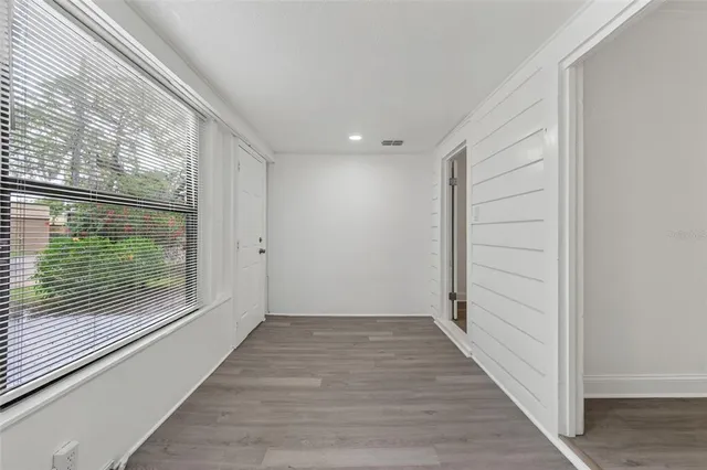 a view of a room with wooden floor and window