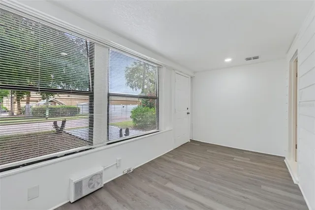 a dining room with furniture and a potted plant