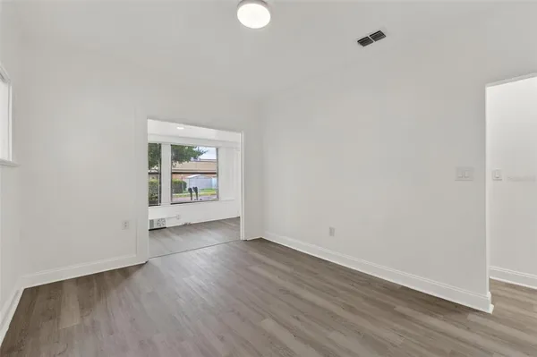 a bedroom with a bed and a potted plant