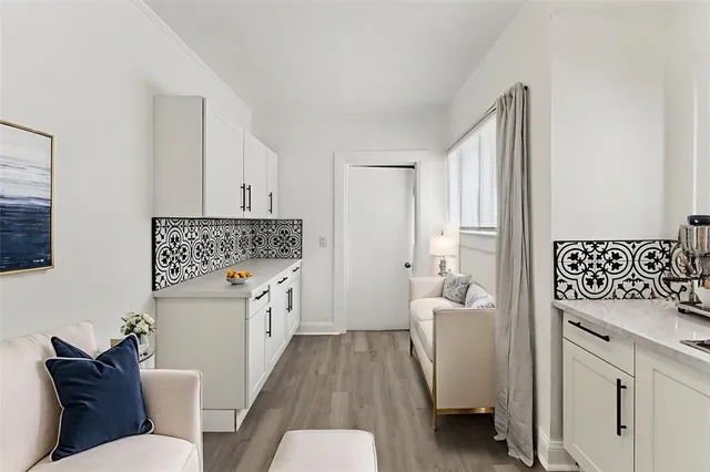 a view of a house with a yard and large tree