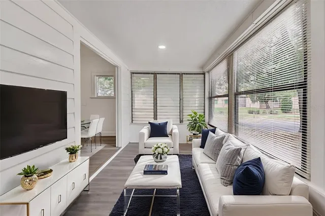 a living room with furniture and a potted plant