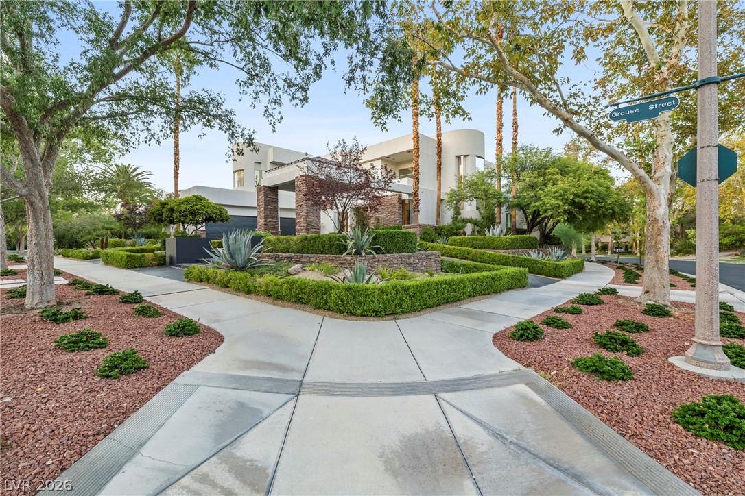 2000 Grouse Street Las Vegas, NV 89134 - Photo 52 of 89 Manicured hedges and desert landscaping surround this grand contemporary residence.