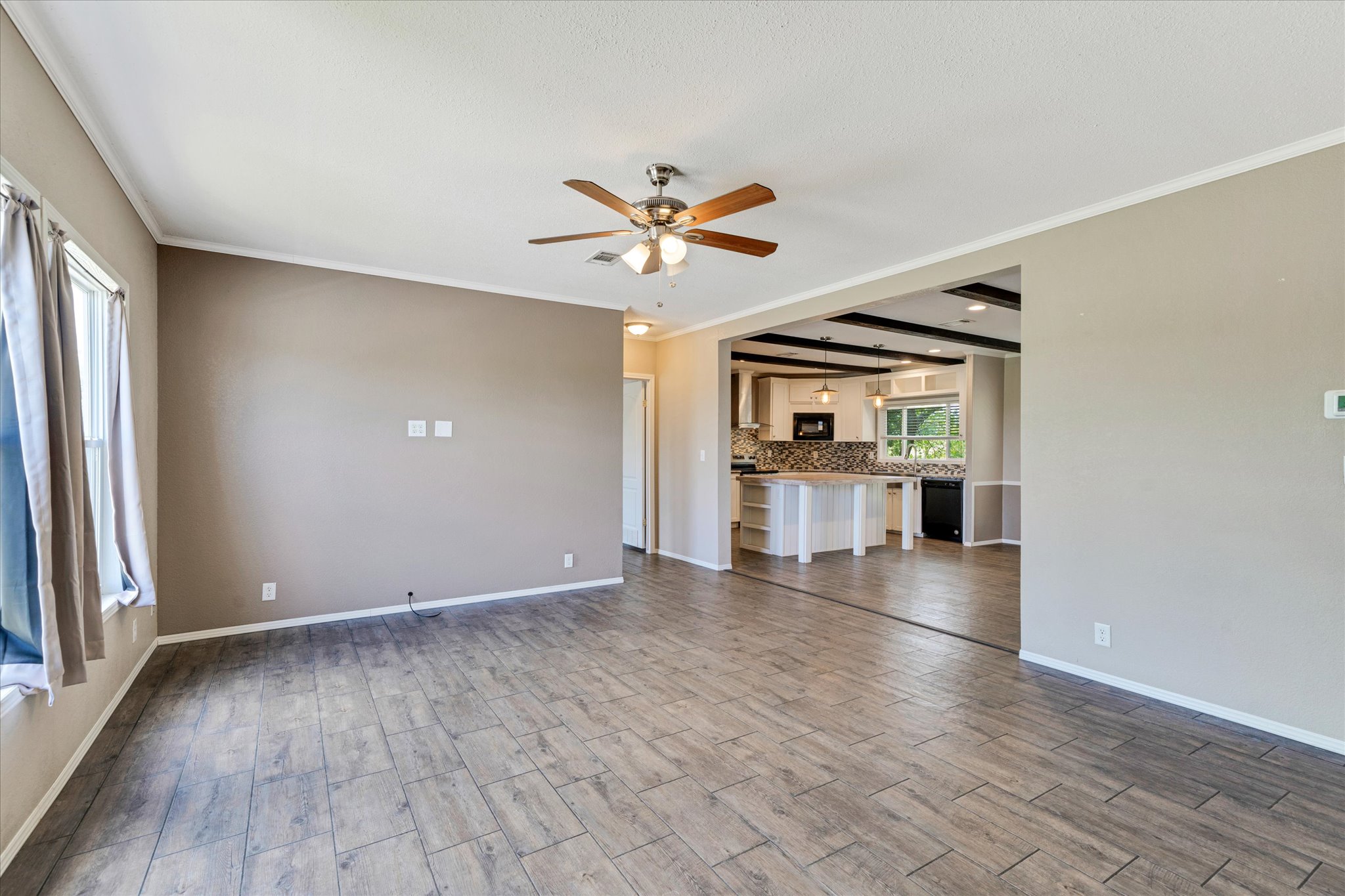 1500 Wattsville Road Luling, TX 78648 - Photo 10 of 38 An open-concept layout connects a spacious living area with a well-appointed kitchen.