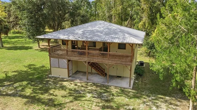 a view of a house with a yard balcony and sitting area
