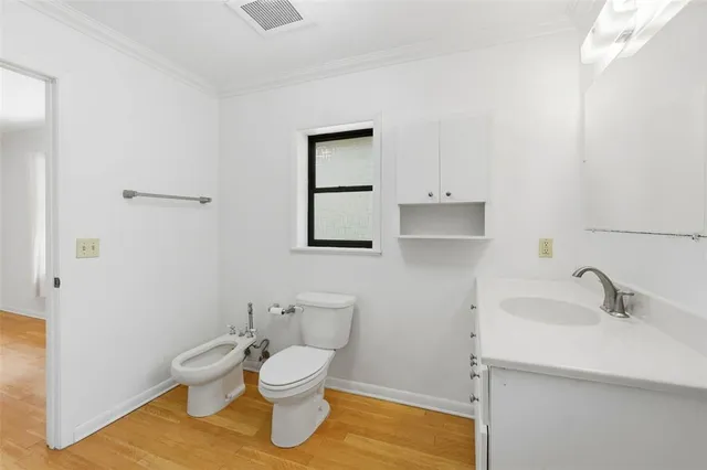 a white toilet sitting next to a bathroom sink