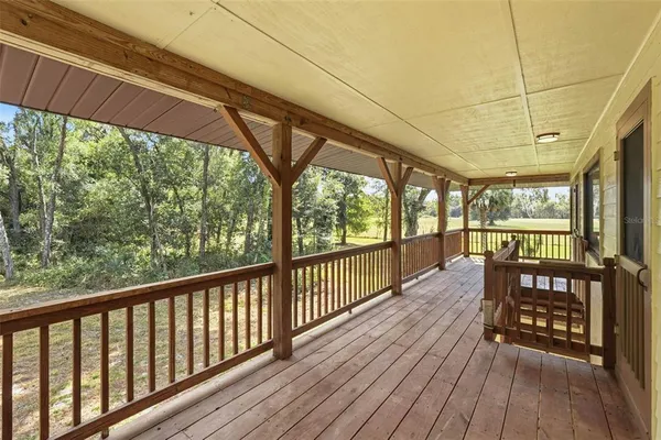 a view of porch with wooden floor