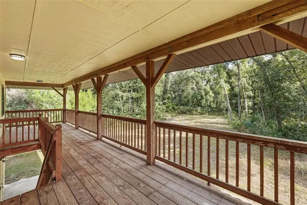 a view of a deck with wooden floor and outdoor space