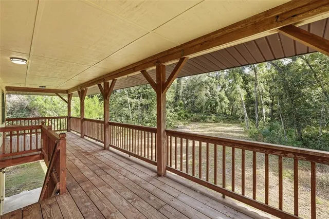 a view of a deck with wooden floor and outdoor space