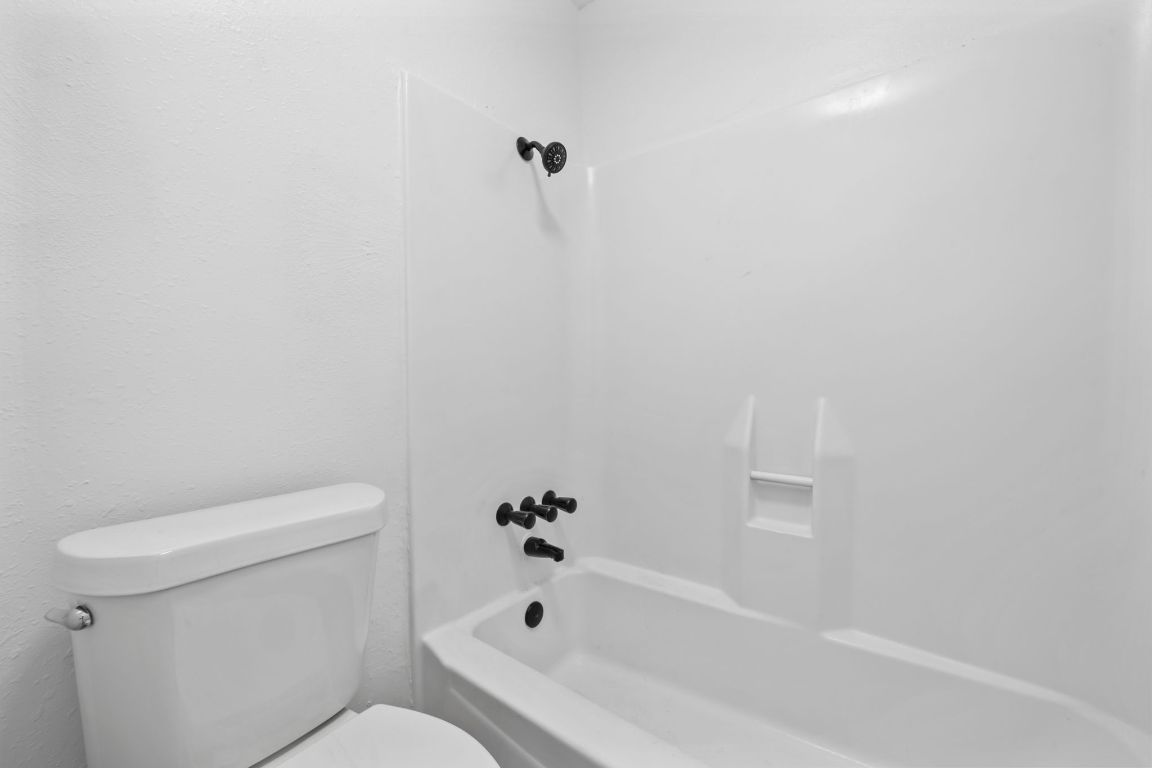 2410 Longview Street, Unit D101 Austin, TX 78705 - Photo 11 of 20 a white bath tub sitting next to a white toilet