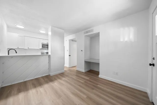 a view of a kitchen with wooden floor