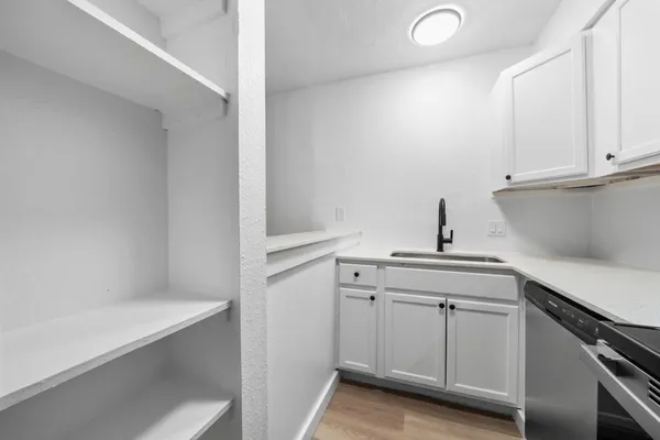 a view of cabinets and wooden floor