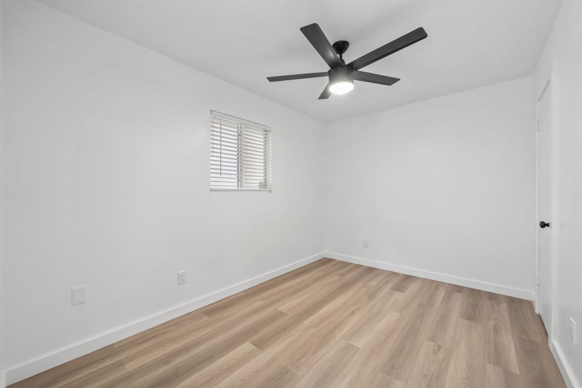 2410 Longview Street, Unit D101 Austin, TX 78705 - Photo 8 of 20 an empty room with a window and a fan