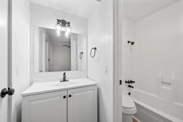 a bathroom with a sink toilet tub and shower