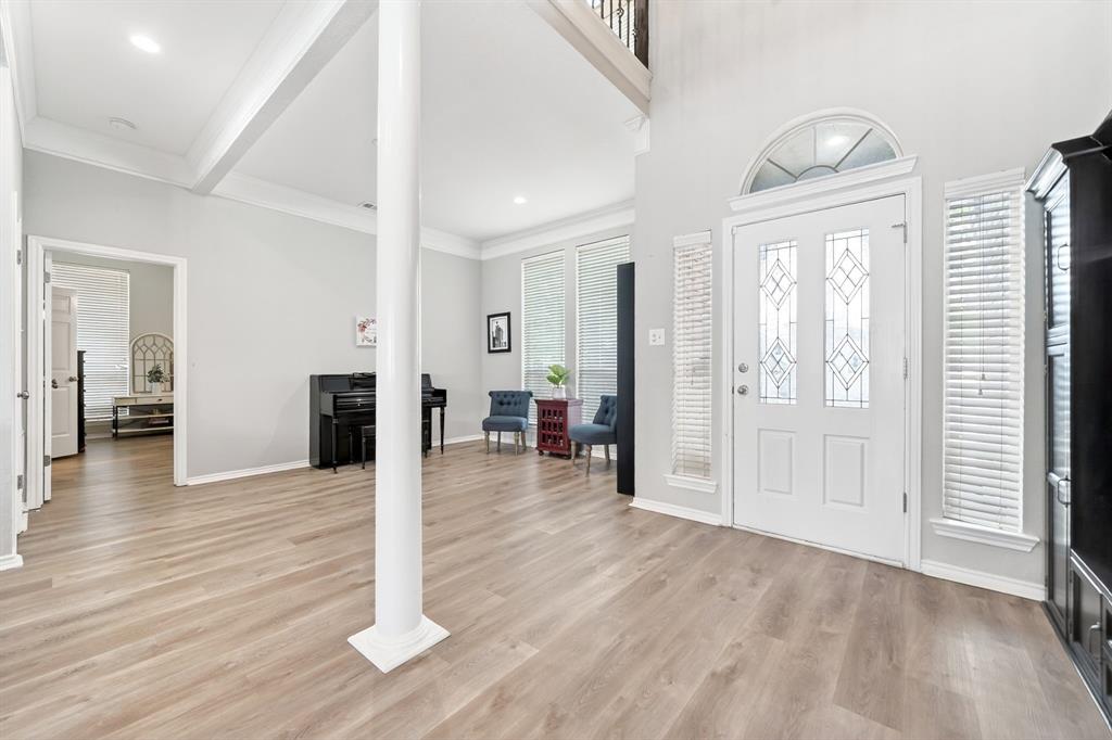 4509 Scenic Drive Rowlett, TX 75088 - Photo 5 of 40 Entryway featuring wood-finish flooring, a decorative glass front door with an arched transom window, and tall windows with blinds
