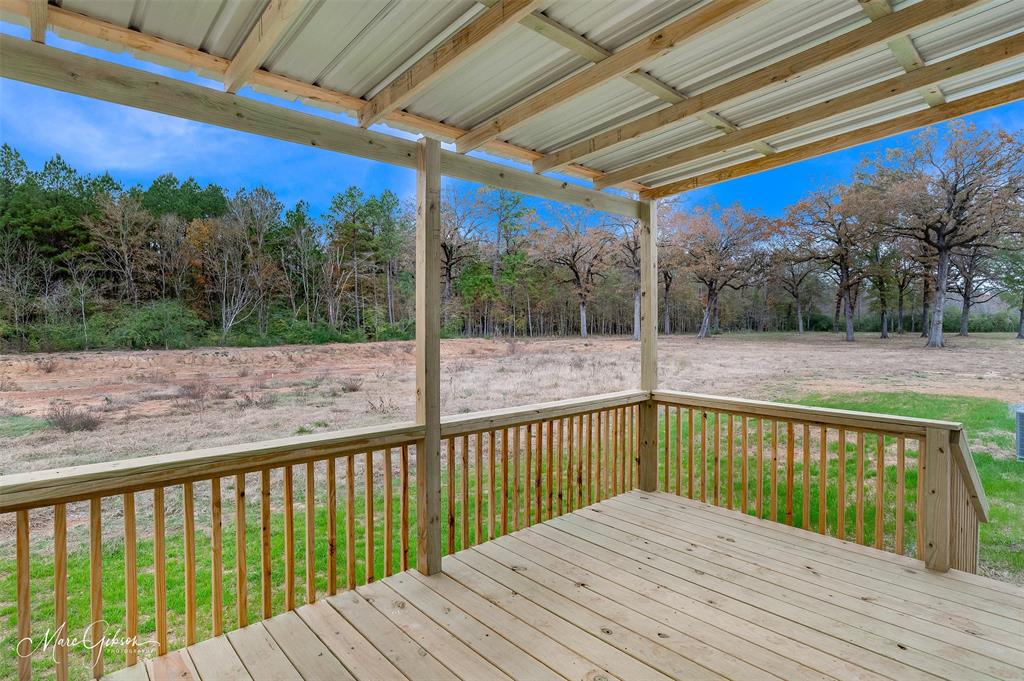 607 Nettleton Drive Princeton, LA 71067 - Photo 14 of 16 a view of balcony with wooden floor and fence