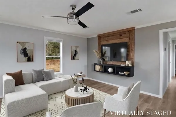 a living room with furniture and a wooden floor