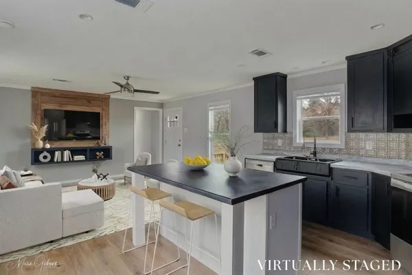 a view of kitchen sink cabinets and refrigerator