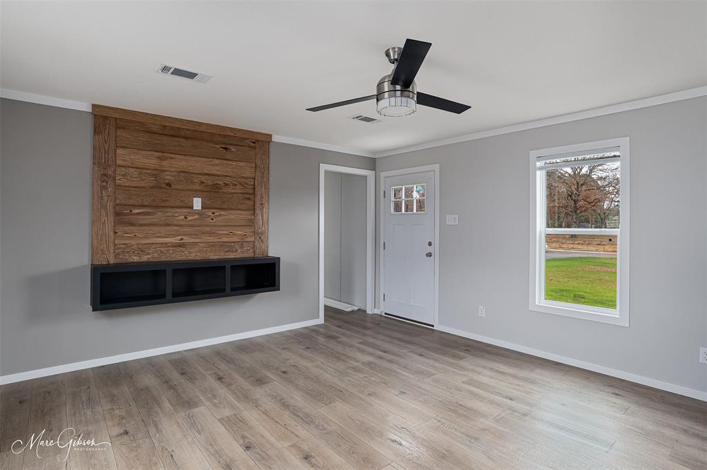 607 Nettleton Drive Princeton, LA 71067 - Photo 7 of 16 a view of an empty room with a window and wooden floor