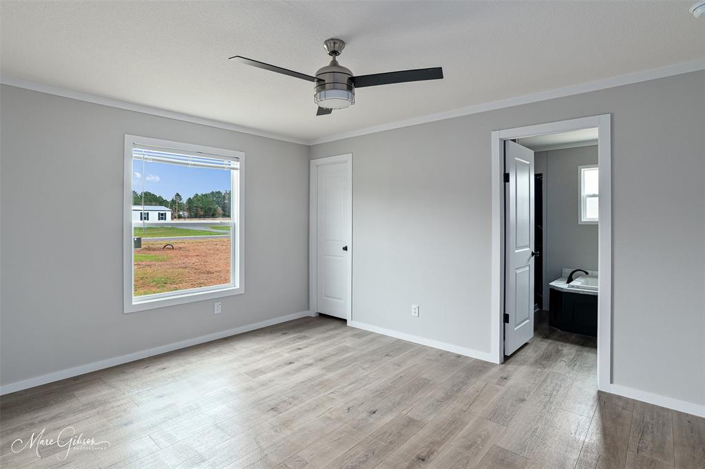 607 Nettleton Drive Princeton, LA 71067 - Photo 8 of 16 wooden floor in an empty room with a window