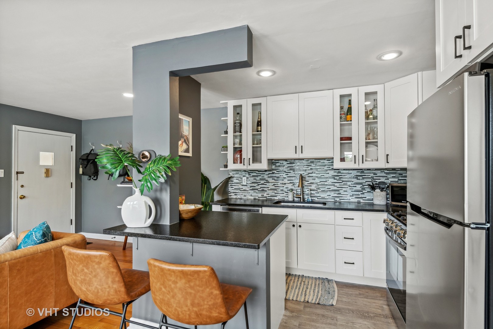 7221 Division Street, Unit 1 River Forest, IL 60305 - Photo 6 of 15 a kitchen with granite countertop a table chairs stove and refrigerator