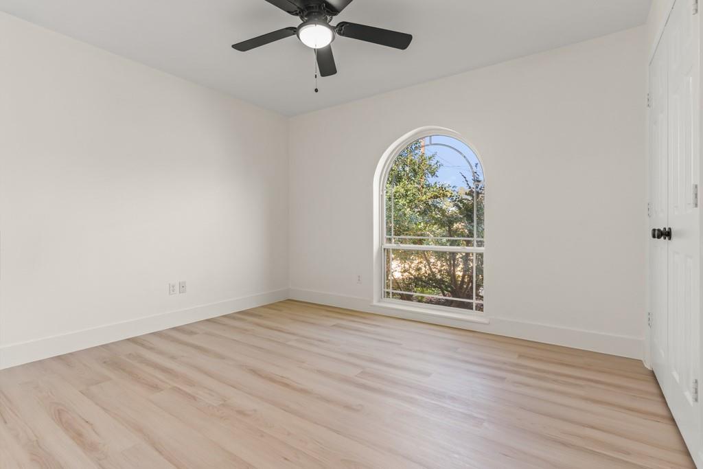 804 Alta Street Longview, TX 75604 - Photo 10 of 20 an empty room with wooden floor fan and windows