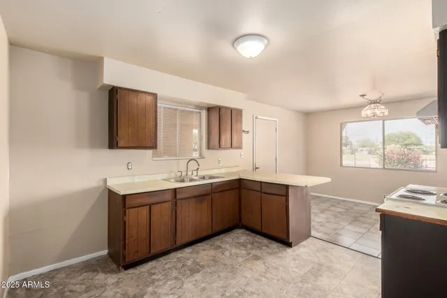 a kitchen with a sink and a stove top oven