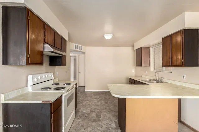 a kitchen with stainless steel appliances a sink a stove and a refrigerator