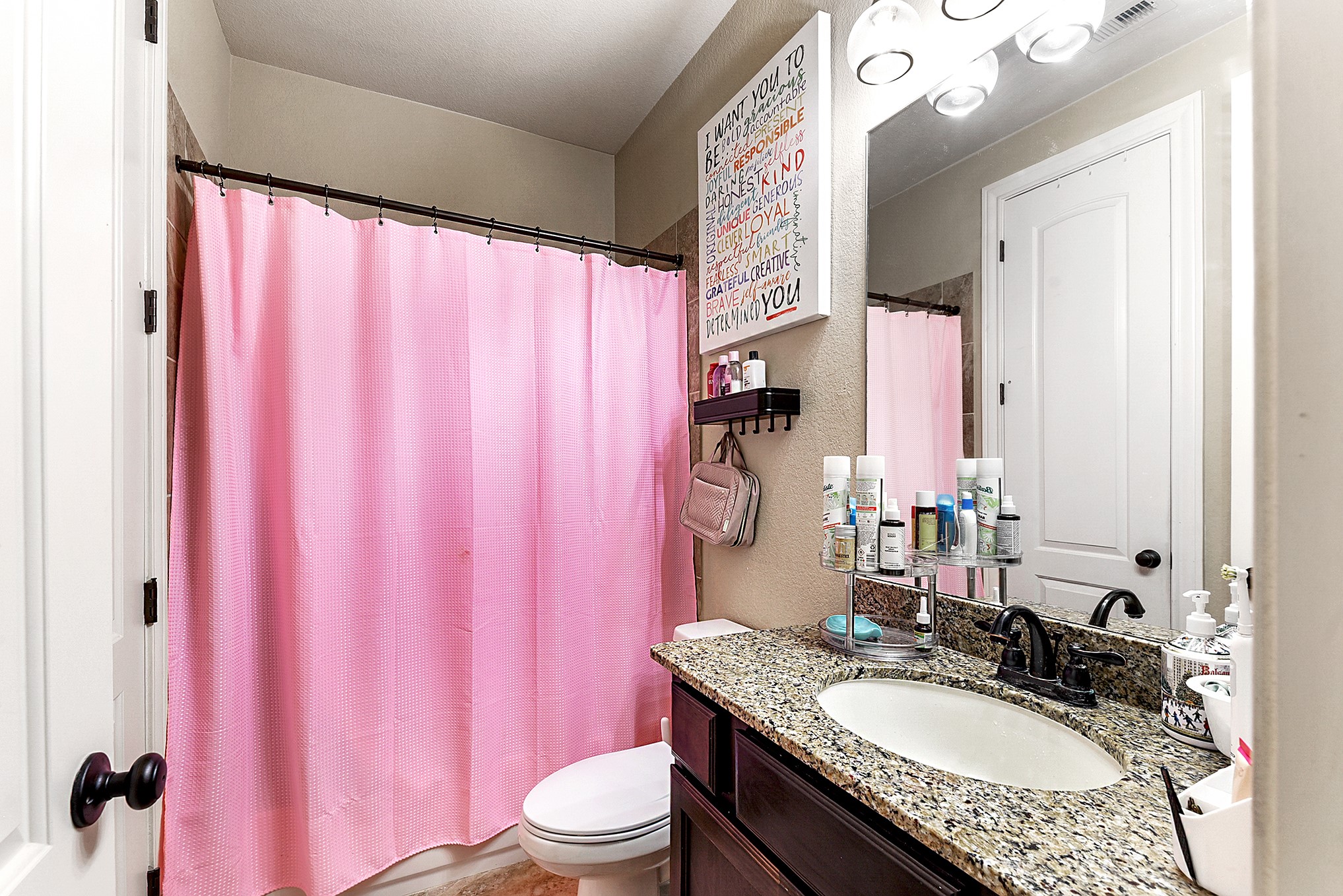 2939 Bobby Jones Road Katy, TX 77494 - Photo 30 of 50 a bathroom with a granite countertop sink vanity mirror and a toilet