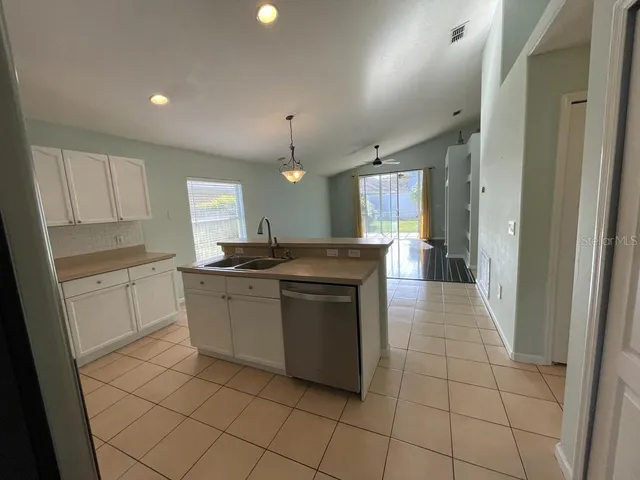 a kitchen with a sink and cabinets