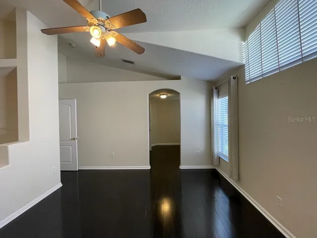 a view of a livingroom with a ceiling fan and window
