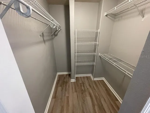 a bathroom with a granite countertop toilet and a sink